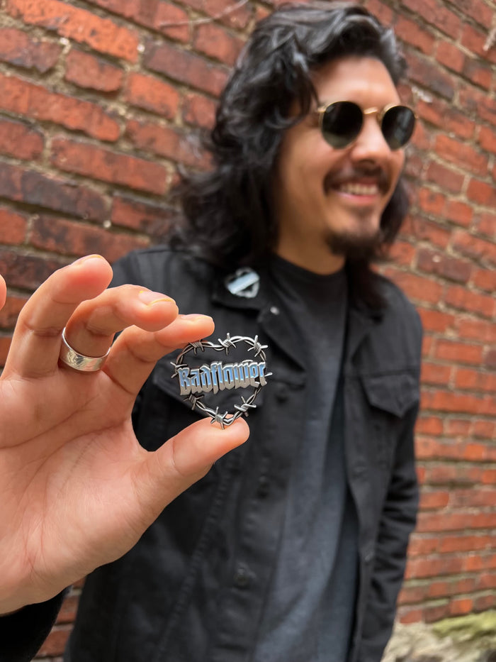 person holding Badflower Heart Pin