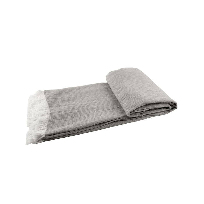 A Declan Ash Bed Throw displayed on a bed.