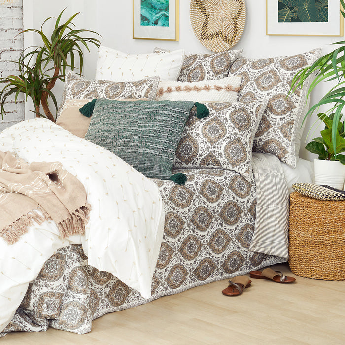 A freddie quilt displayed on a made bed.