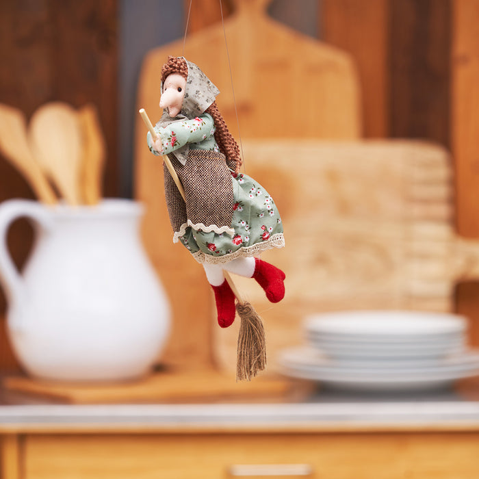A Green Kitchen Witch Figurine.