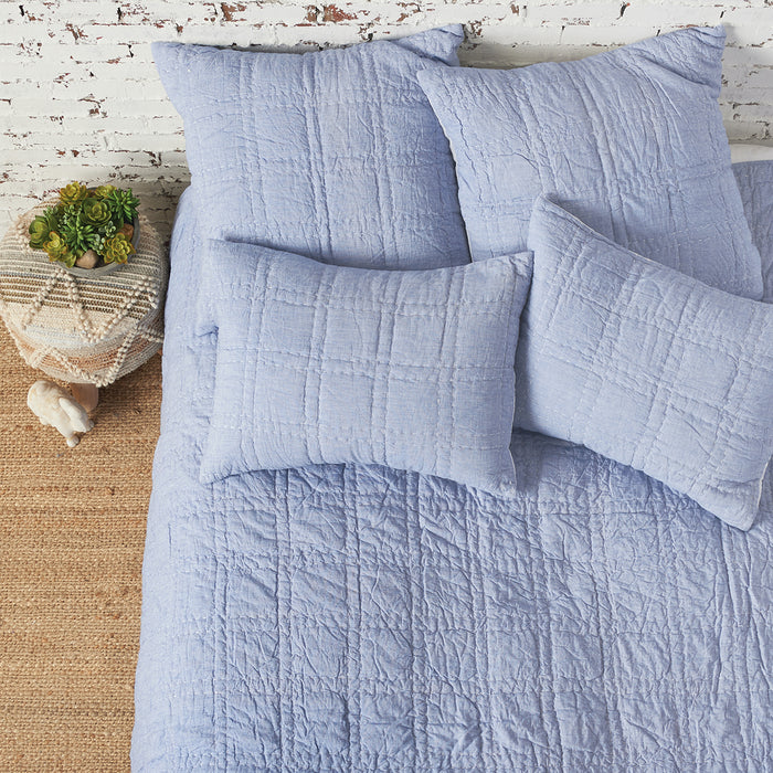 A hugh quilt displayed on a made bed.