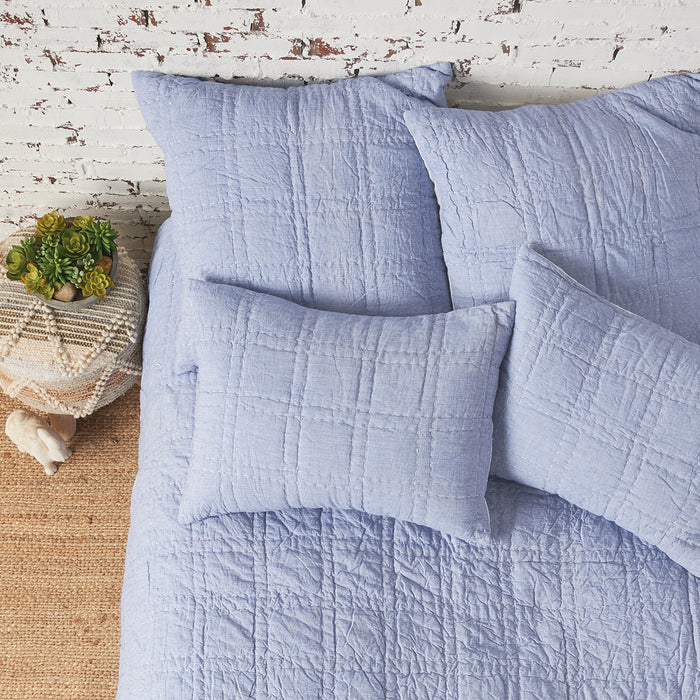 A hugh quilt displayed on a made bed.