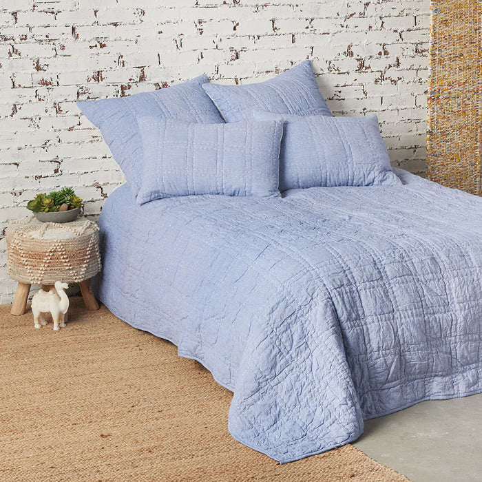 A hugh quilt displayed on a made bed.