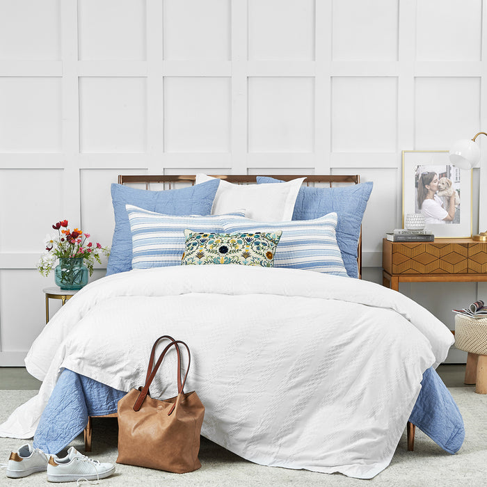 A hugh quilt displayed on a made bed.
