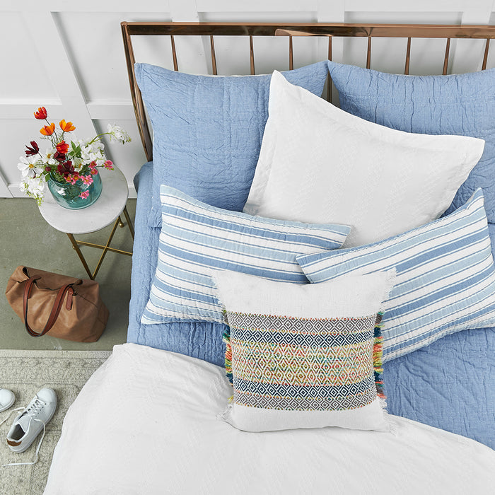 A hugh quilt displayed on a made bed.