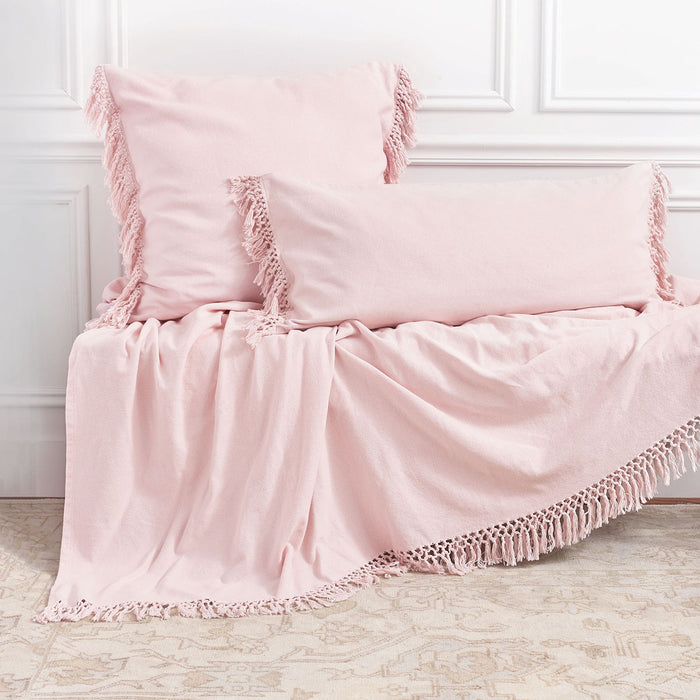 A Lavato Bed Throw displayed on a bed.