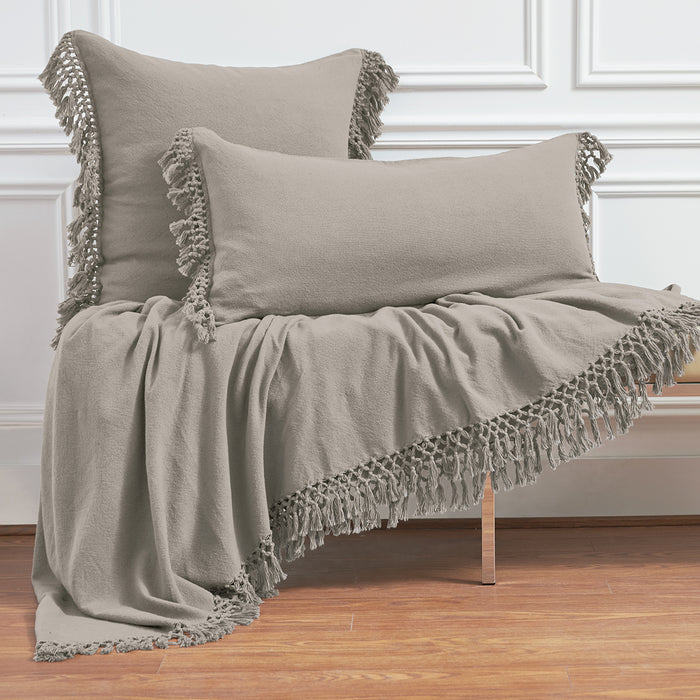 A Lavato Bed Throw displayed on a bed.