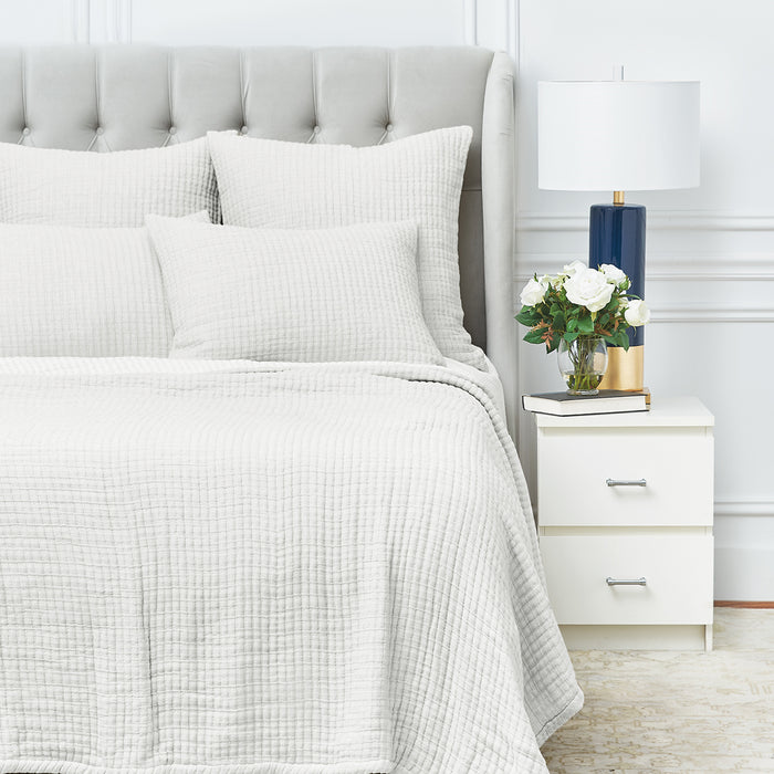 A Lida Coverlet displayed on a bed.