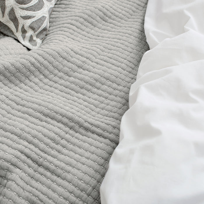 A Lida Coverlet displayed on a bed.
