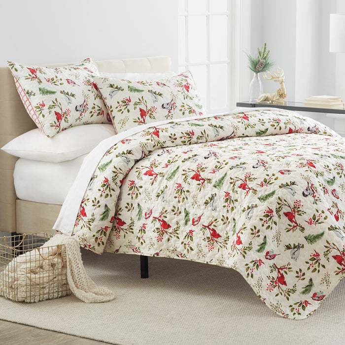 A Nature's Holiday Quilt Set displayed on a made bed.