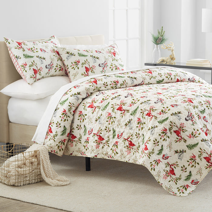 A Nature's Holiday Quilt Set displayed on a made bed.