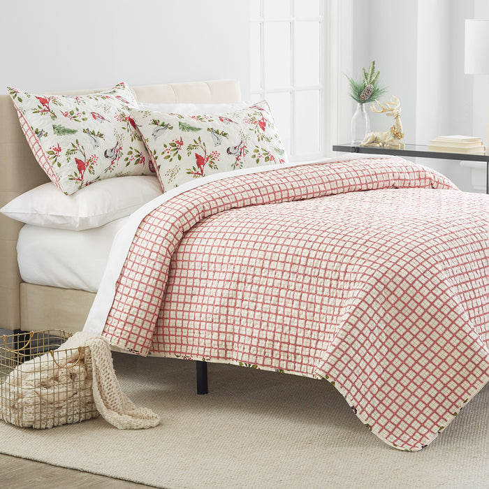 A Nature's Holiday Quilt Set displayed on a made bed.