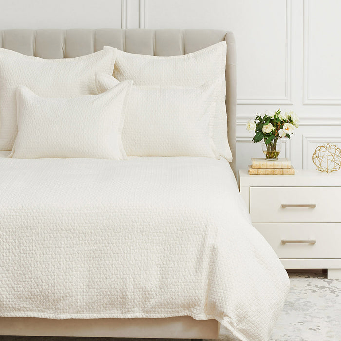 A Pernille Duvet Cover displayed on a bed.