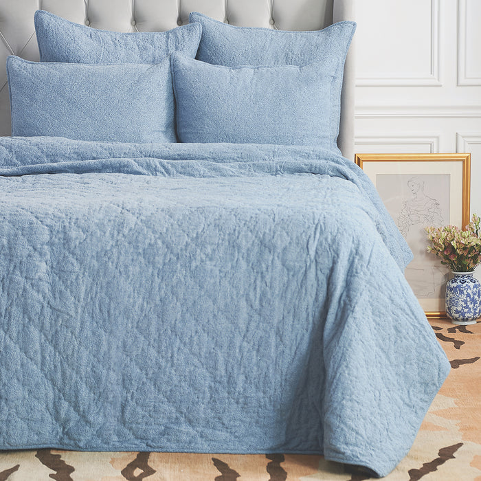 A Savina Quilt displayed on a made bed.