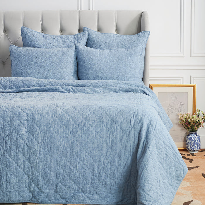 A Savina Quilt displayed on a made bed.
