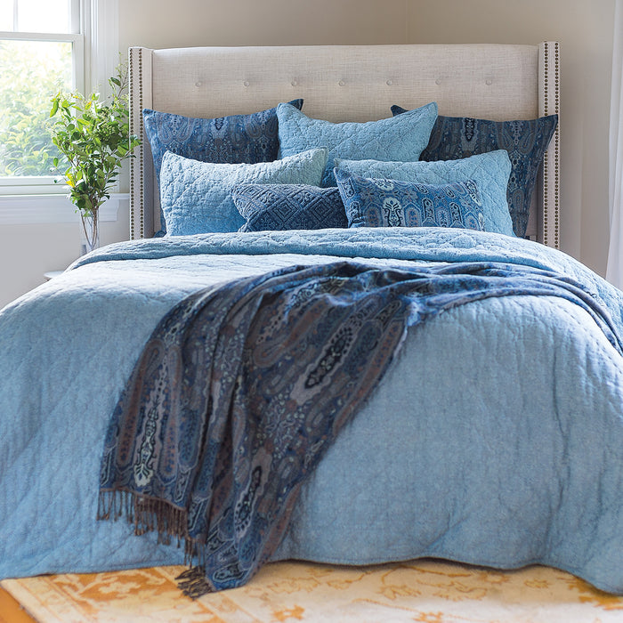 A Savina Quilt displayed on a made bed.