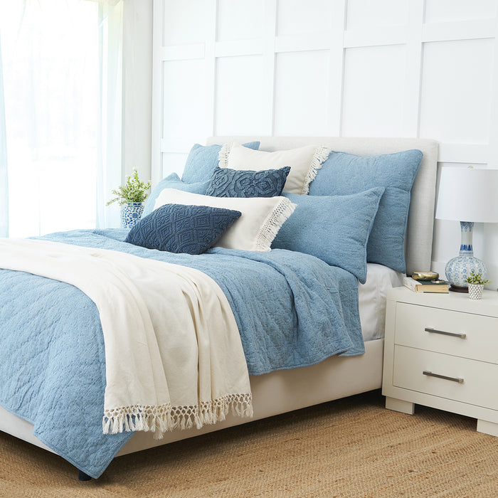 A Savina Quilt displayed on a made bed.