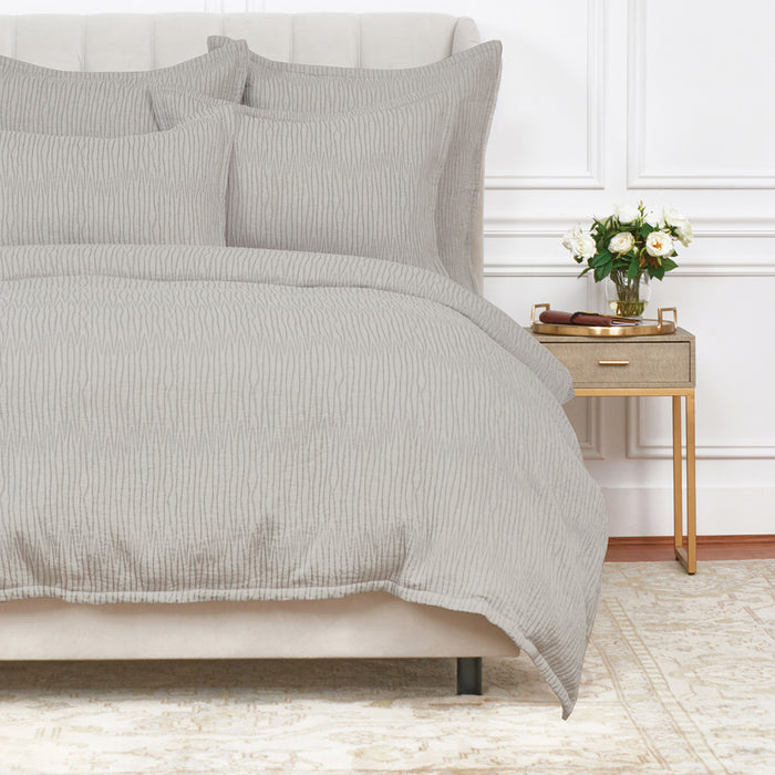 A Simone Duvet Cover displayed on a bed.