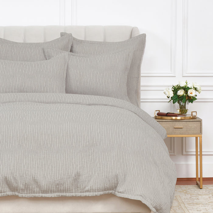 A Simone Duvet Cover displayed on a bed.