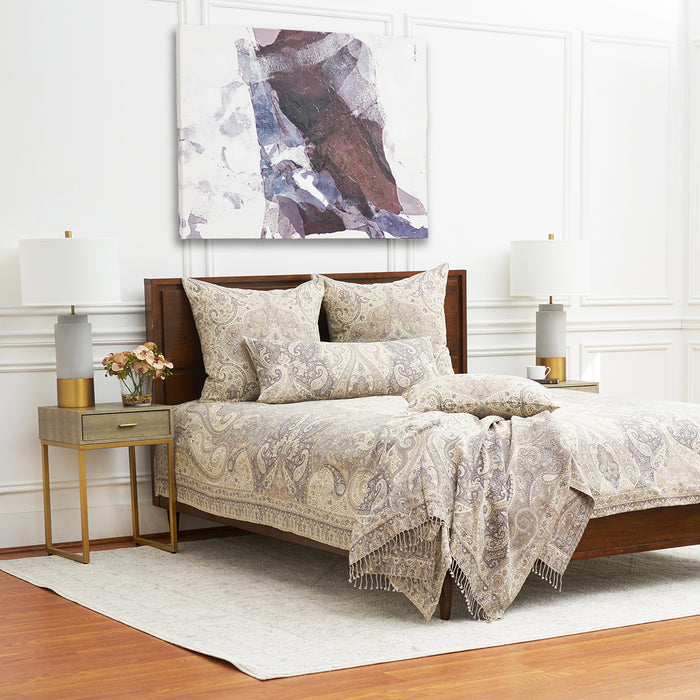 A Suman Coverlet displayed on a bed.