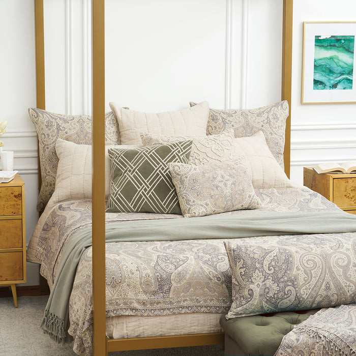 A Suman Coverlet displayed on a bed.