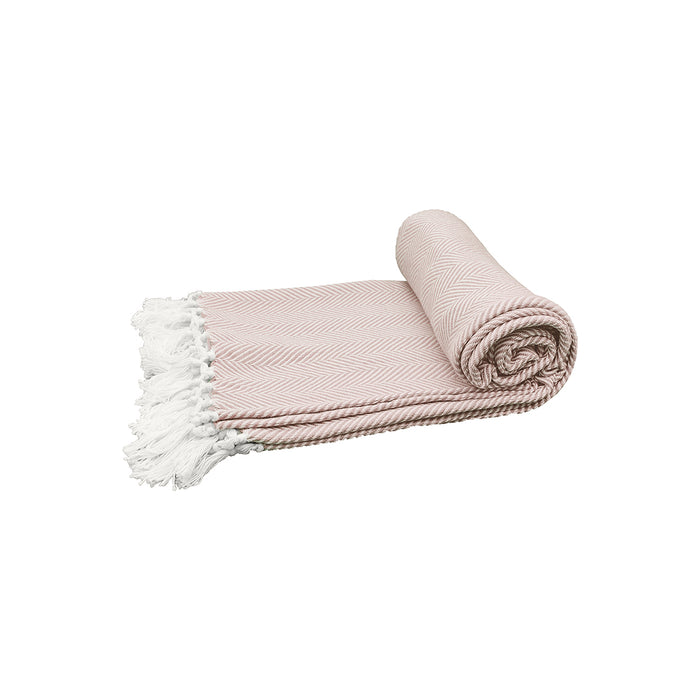 A rolled up pink beige throw blanket with a herringbone pattern and white fringes on a light background.