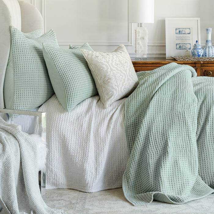 A Waffle Coverlet displayed on a bed.