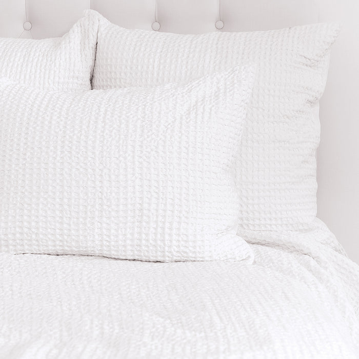 A Waffle Coverlet displayed on a bed.