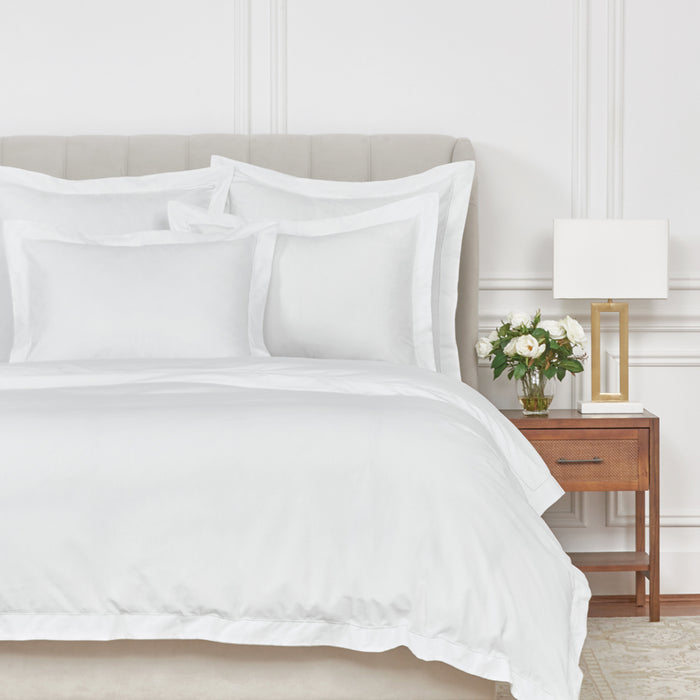 A Whitaker Duvet Cover displayed on a bed.